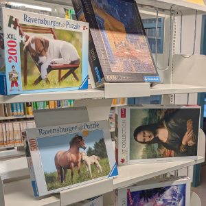 jigsawpuzzles in a shelf